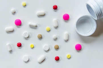 Top view of the pills on the white background, The drug and capsule pills on the floor, Pile of the drug and pills on the white background.