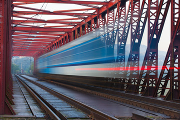 Fototapeta premium Speed train on the iron railway bridge, Czech Republic