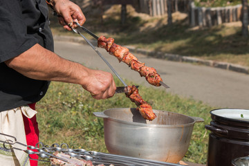 barbeque grill, skewers with meat, brazier, cauldron, chef controls willingness dishes