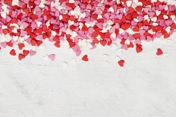 Multi-colored hearts on a white background. Top view, copy space