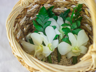 Wedding boutonniere flowers in wicker basket
