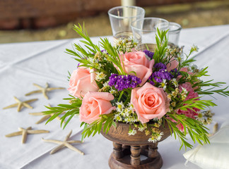 Bouquets flowers in vase and Wedding Sand Ceremony on the  table
