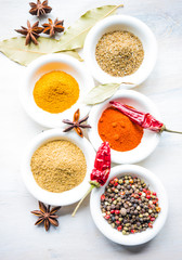 Different spices on white wooden table