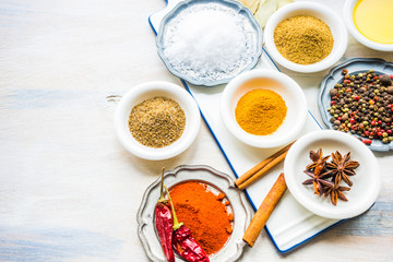 Different spices on white wooden table