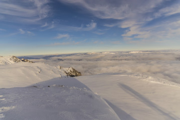 peaks of mountains above the clouds