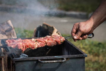 barbeque grill, skewers with meat, brazier, cauldron, chef controls willingness dishes