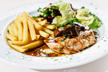 meat with french fries and salad