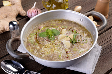 Saucepan with vegetable and cereal soup