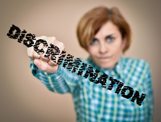 Woman hitting and breaking word discrimination with her fist. Selective focus.