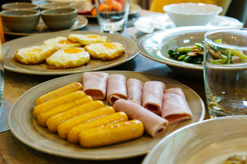 close up of sausage with ham and fried egg