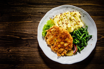 Fried pork chop, mashed potatoes and green beans