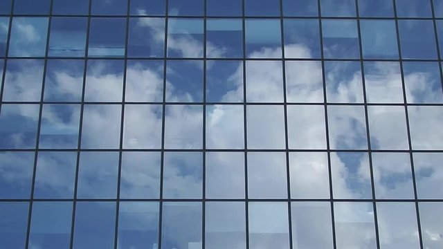 Reflection of clouds in the glass surface of a high-rise building