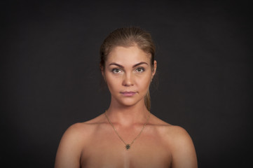 Fototapeta premium Portrait of emotional girl on a dark background.