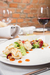 Starter: Mix salads, baked goat cheese, sea-buckthorn jam, caramelized pear with thyme, plum and roast nuts - served in a restaurant