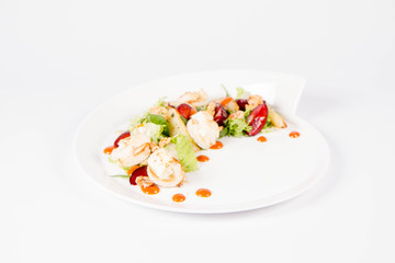 Starter: Mix salads, baked goat cheese, sea-buckthorn jam, caramelized pear with thyme, plum and roast nuts - on a white background