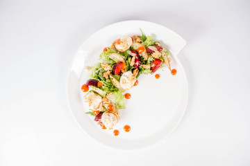 Starter: Mix salads, baked goat cheese, sea-buckthorn jam, caramelized pear with thyme, plum and roast nuts - on a white background
