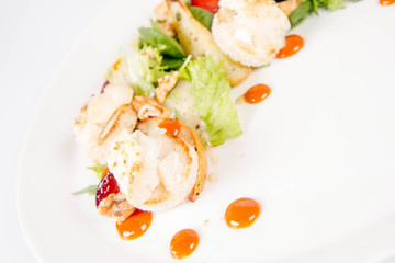 Starter: Mix salads, baked goat cheese, sea-buckthorn jam, caramelized pear with thyme, plum and roast nuts - on a white background