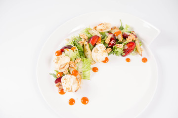 Starter: Mix salads, baked goat cheese, sea-buckthorn jam, caramelized pear with thyme, plum and roast nuts - on a white background