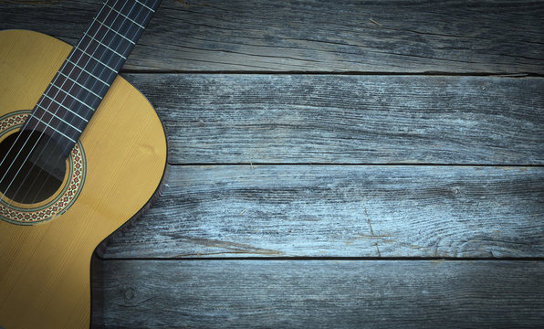 Classical guitar on a wooden background - Powered by Adobe