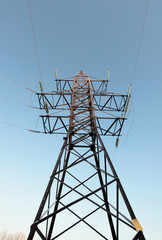 high voltage pole with wires on a background blue sky