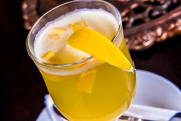 White mulled wine with slice of orange and spices