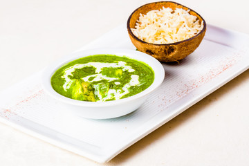 Palak paneer with rice on white plate. Indian cuisine