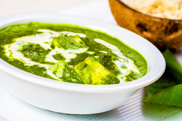 Palak paneer with rice on white plate. Indian cuisine