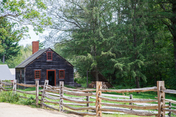 Fototapeta na wymiar Black wooden house near forest