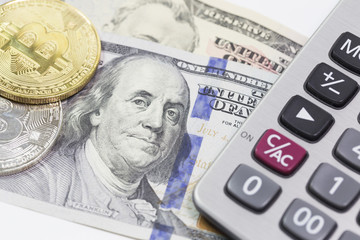 Bitcoins and dollars with calculator in background 