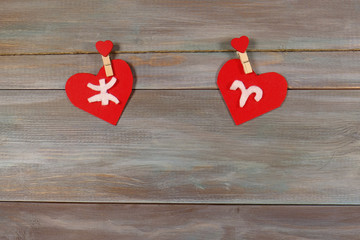 Pisces and Aries. signs of the zodiac and heart. wooden backgrou