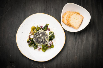 Vegan tartar with wakame seaweed and black sesame, top view