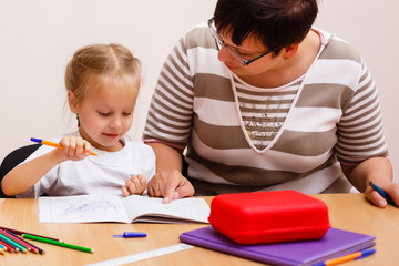 Mom helping her daughter do her homework