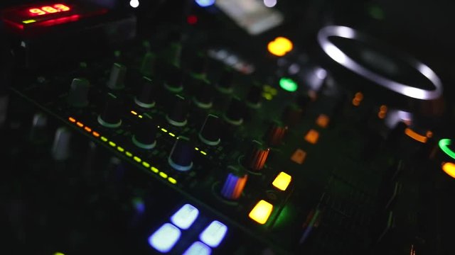 Dj hands playing and mixing music in a nightclub