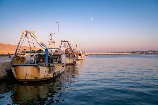 Sunset Over Trawler Fishing Boat Docket In Harbour. Apulia, Italy