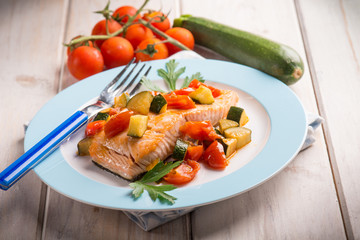 salmon with fresh tomatoes and zucchinis, selective focus