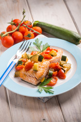 salmon with fresh tomatoes and zucchinis, selective focus