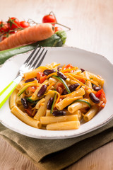 pasta with beans carrot zucchinis and fresh tomatoes, selective focus