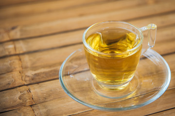 hot chinese tea in glass with wood background