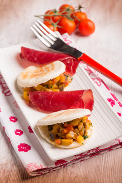 tigelle with bresaola and vegetables, selective focus