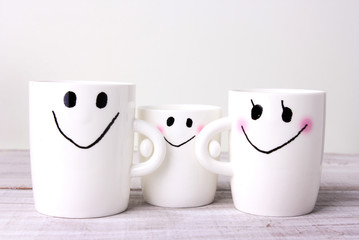Family concept white mugs.Mother,father,baby.