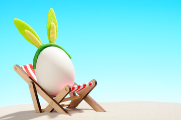 Egg in lounger on beach