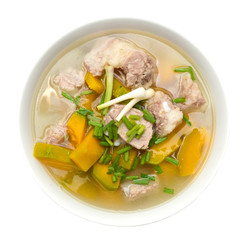 pumpkin soup with meat in bowl on white