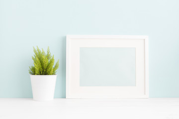 White frame mock up and a blank photo frame on a book shelf.