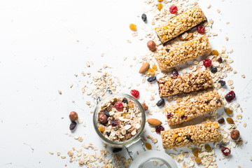 Granola bar with nuts, fruit and berries on white.