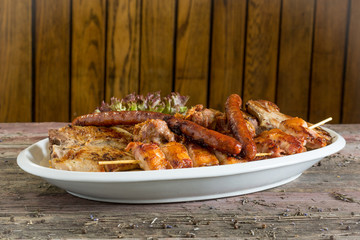 Balkan specialities - a plate of mixed meat including cevapi, pljeskavica, roasted pork neck and...