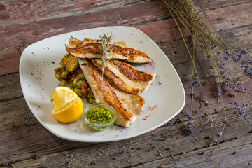 Fish trout. Portion Smoked fillet trout with vegetable dill and lemon. Fish with vegetable salad on...