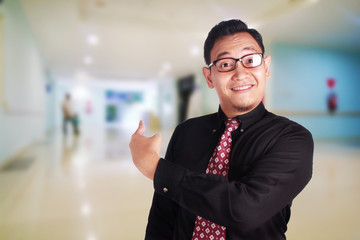 Happy Businessman Pointing Behind