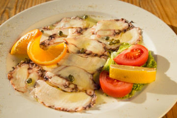 Fototapeta na wymiar Octopus carpaccio with capers in olive oi, restaurant, Croatia