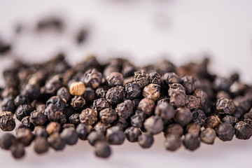close up detail whole peppercorn on white background with low focus