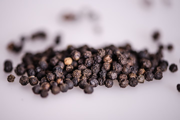 close up detail whole peppercorn on white background with low focus